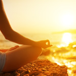 hand of  woman meditating in a yoga pose on beach