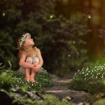 Magic fairy forest. A small child watching fireflies. A fairy tale for children