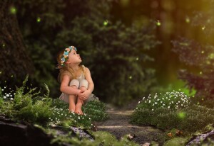 Magic fairy forest. A small child watching fireflies. A fairy tale for children